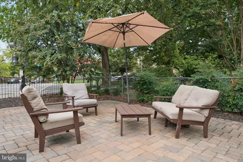 a patio with a patio table and chairs