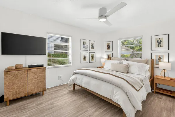 a bedroom with a bed and a flat screen tv