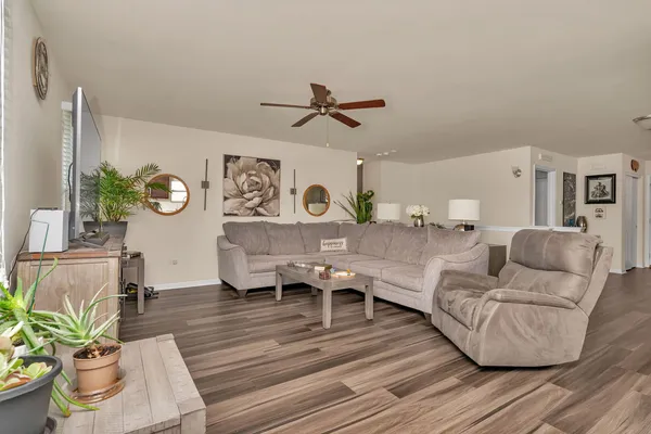 a living room with furniture and a wooden floor