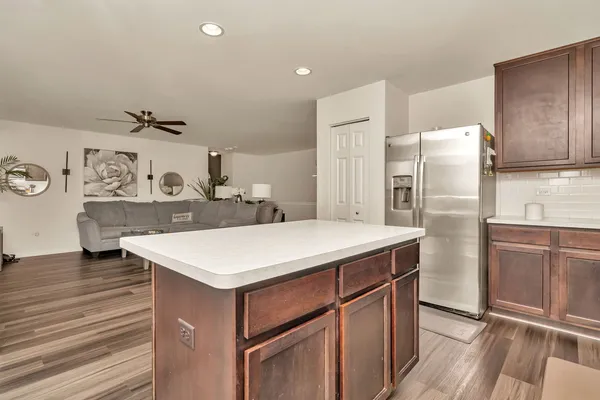 a kitchen with a refrigerator a sink and cabinets