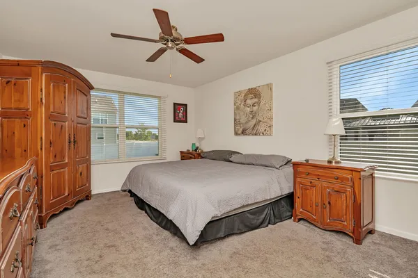 a bedroom with a bed dresser and a window