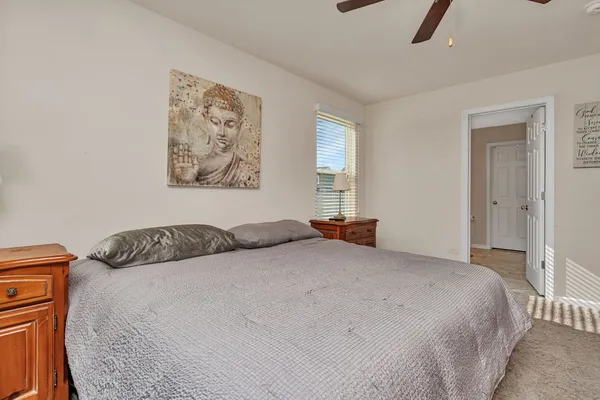 a bedroom with a bed and a painting on the wall