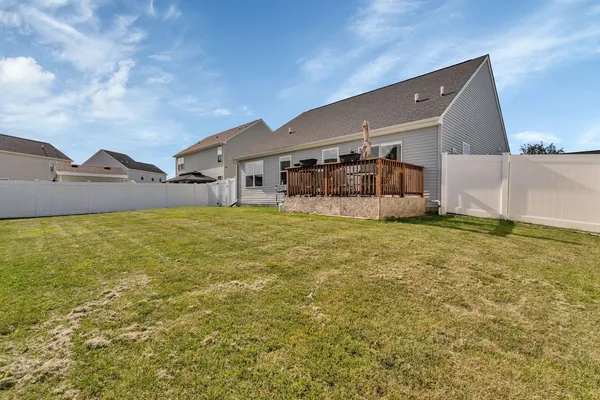 a view of a house with yard and sitting area