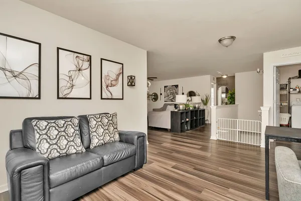 a living room with furniture and wooden floor