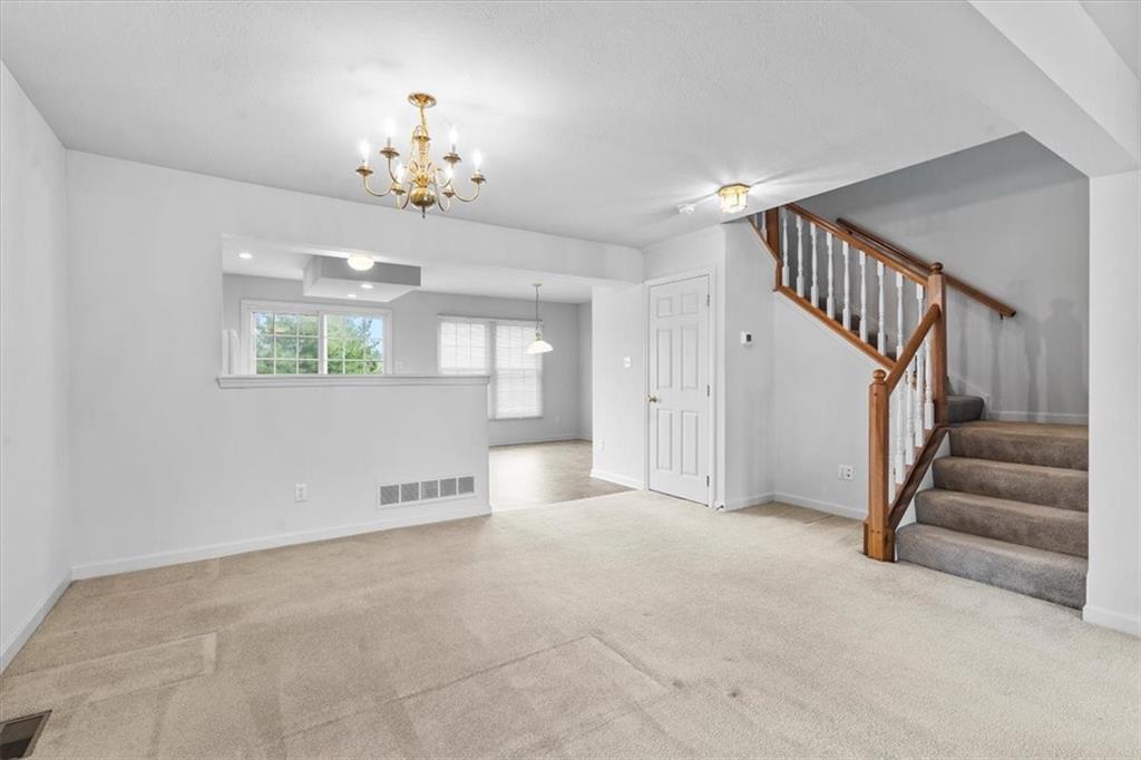 14 Castle View Drive McKees Rocks, PA 15136 - Photo 6 of 28 a view of an empty room with a chandelier fan and windows