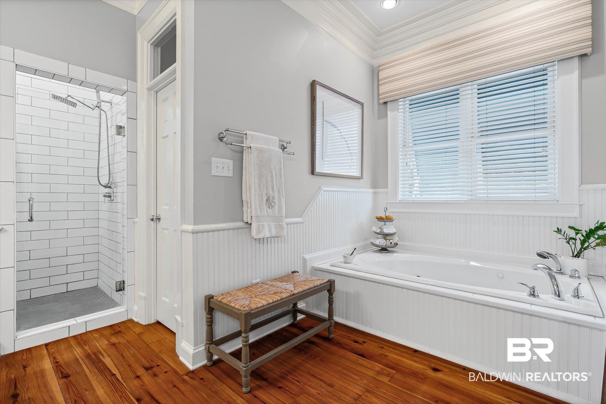 7015 Bay Road Mobile, AL 36605 - Photo 23 of 53 Bathroom featuring crown molding, a wainscoted wall, a shower stall, a bath, and dark wood-type flooring