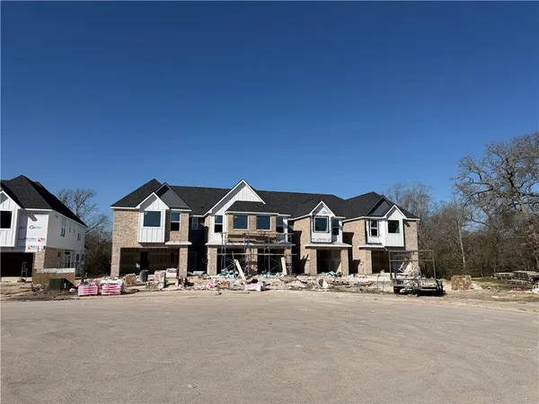 a front view of a house with a yard covered in snow