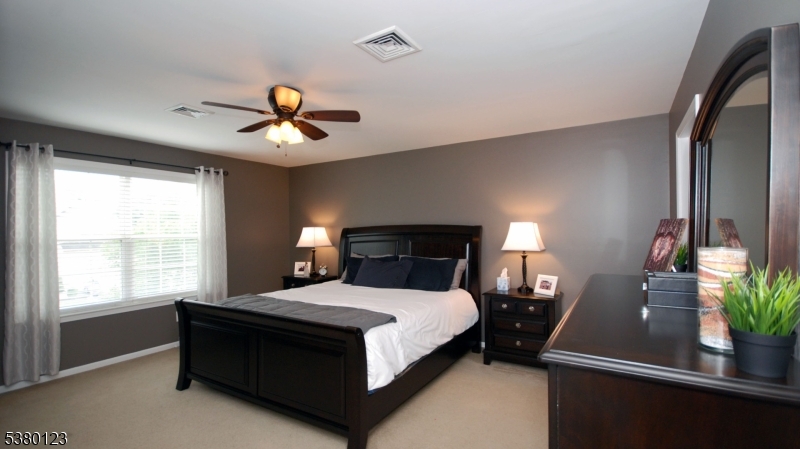 32 Peterson Road Hillsborough, NJ 08844 - Photo 17 of 38 a bedroom with a bed and a chandelier