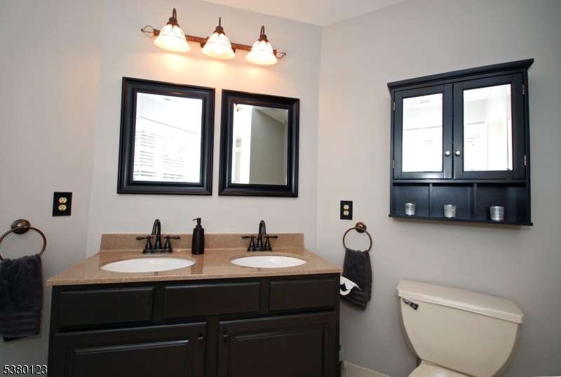 32 Peterson Road Hillsborough, NJ 08844 - Photo 21 of 38 a bathroom with a toilet a sink and mirror