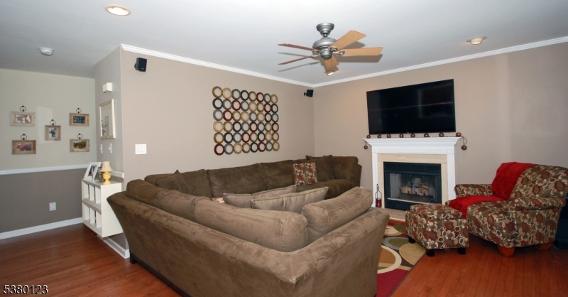 32 Peterson Road Hillsborough, NJ 08844 - Photo 5 of 38 a living room with furniture a fireplace and a flat screen tv