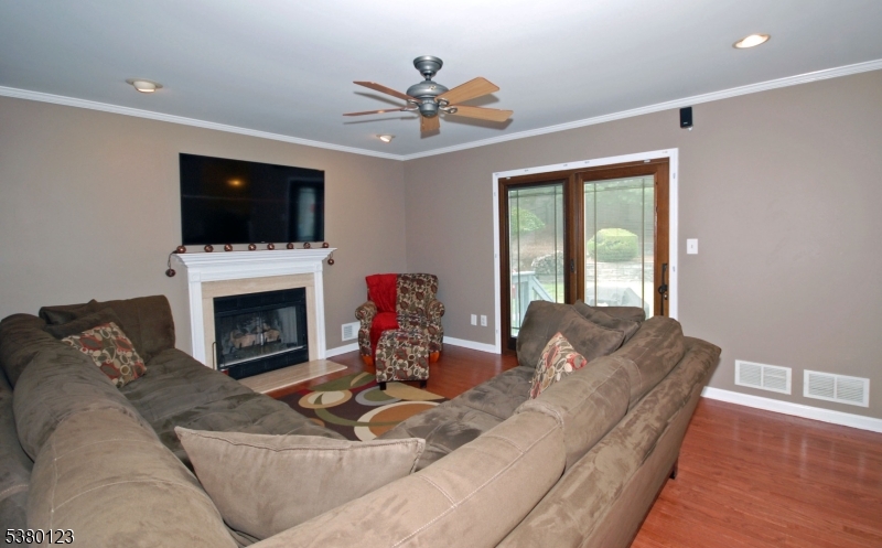 32 Peterson Road Hillsborough, NJ 08844 - Photo 7 of 38 a living room with furniture a fireplace and a flat screen tv