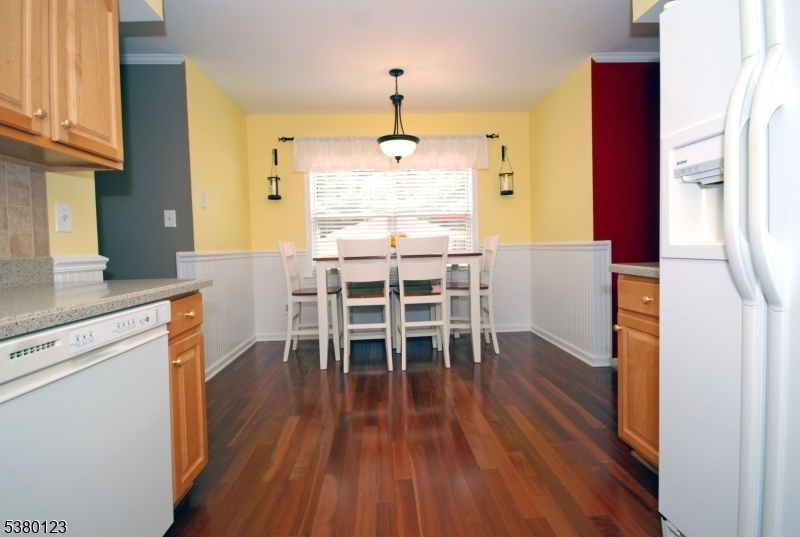 32 Peterson Road Hillsborough, NJ 08844 - Photo 9 of 38 a dining room with wooden floor a chandelier a wooden table and chairs