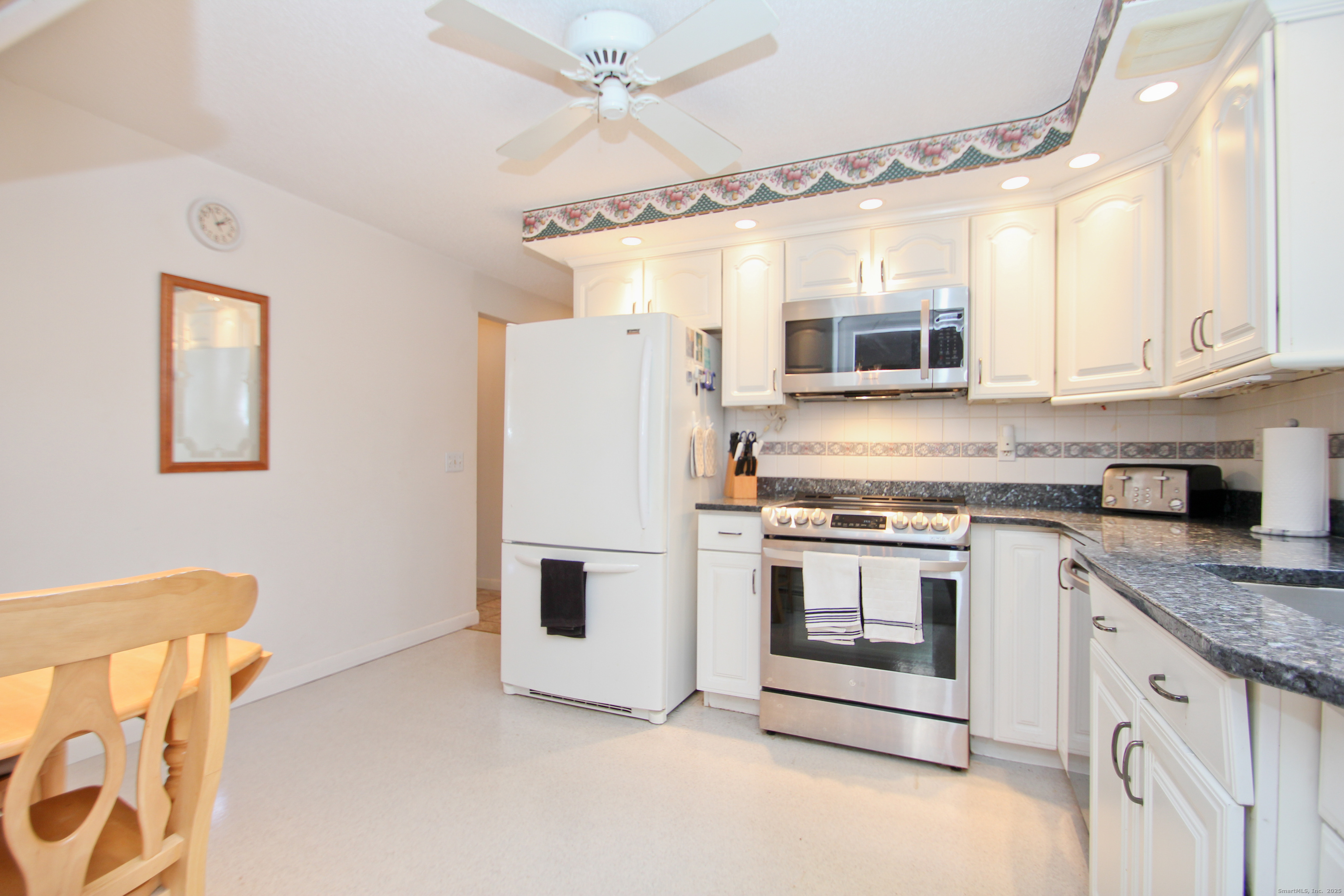 11 Northfield Road Enfield, CT 06082 - Photo 11 of 34 a kitchen with granite countertop white cabinets and white appliances