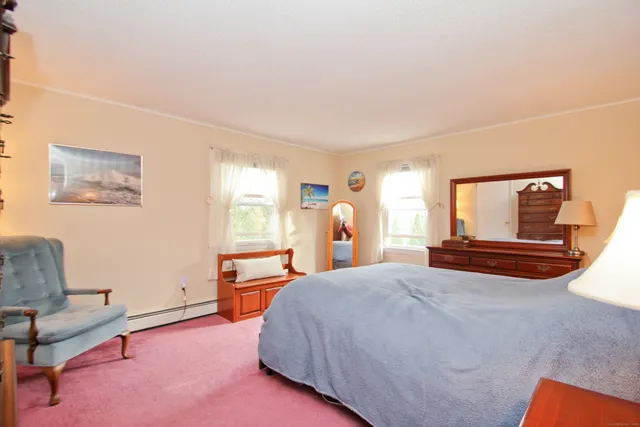 a spacious bedroom with a bed and furniture