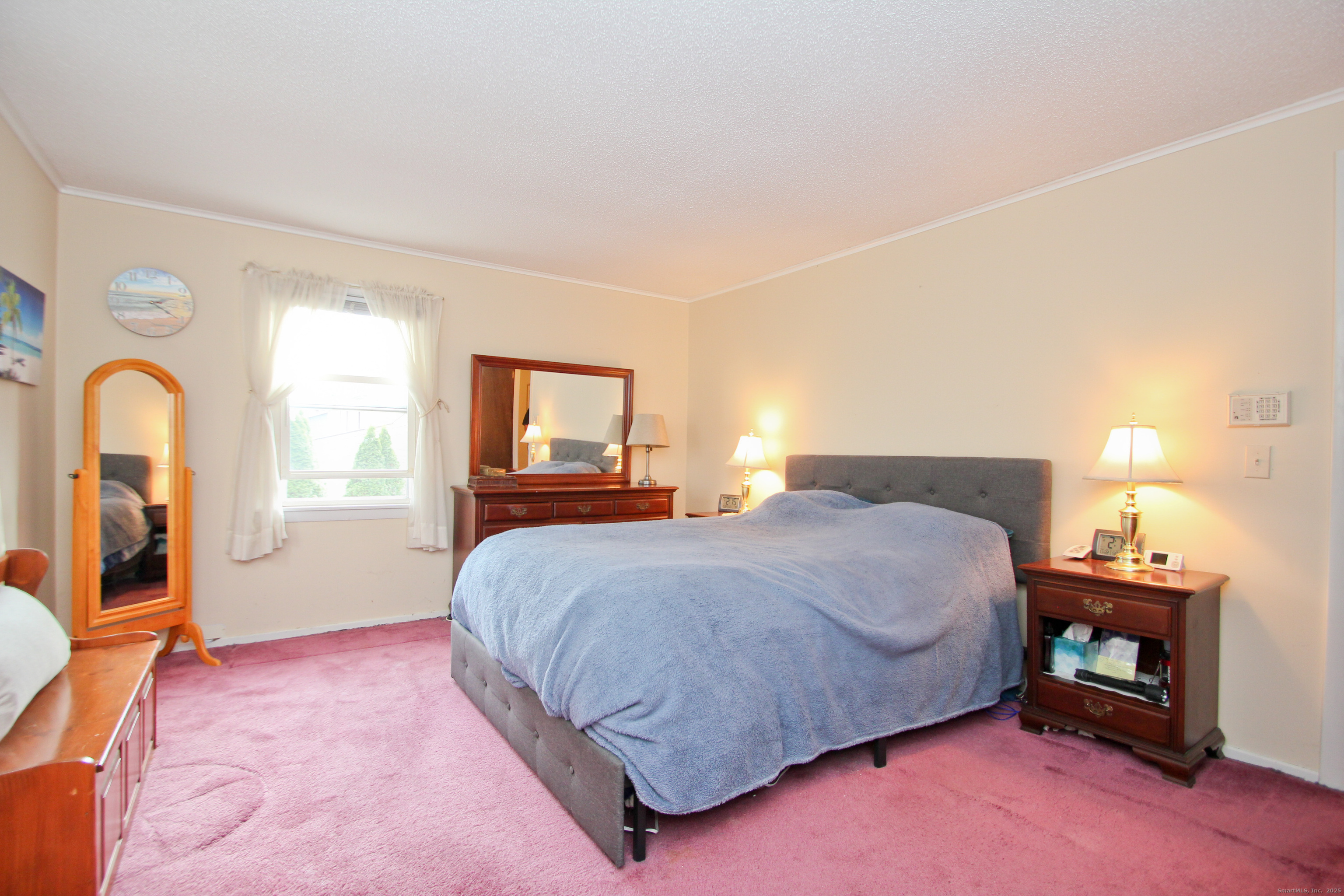 11 Northfield Road Enfield, CT 06082 - Photo 22 of 34 a bedroom with a bed and a lamp next to a window