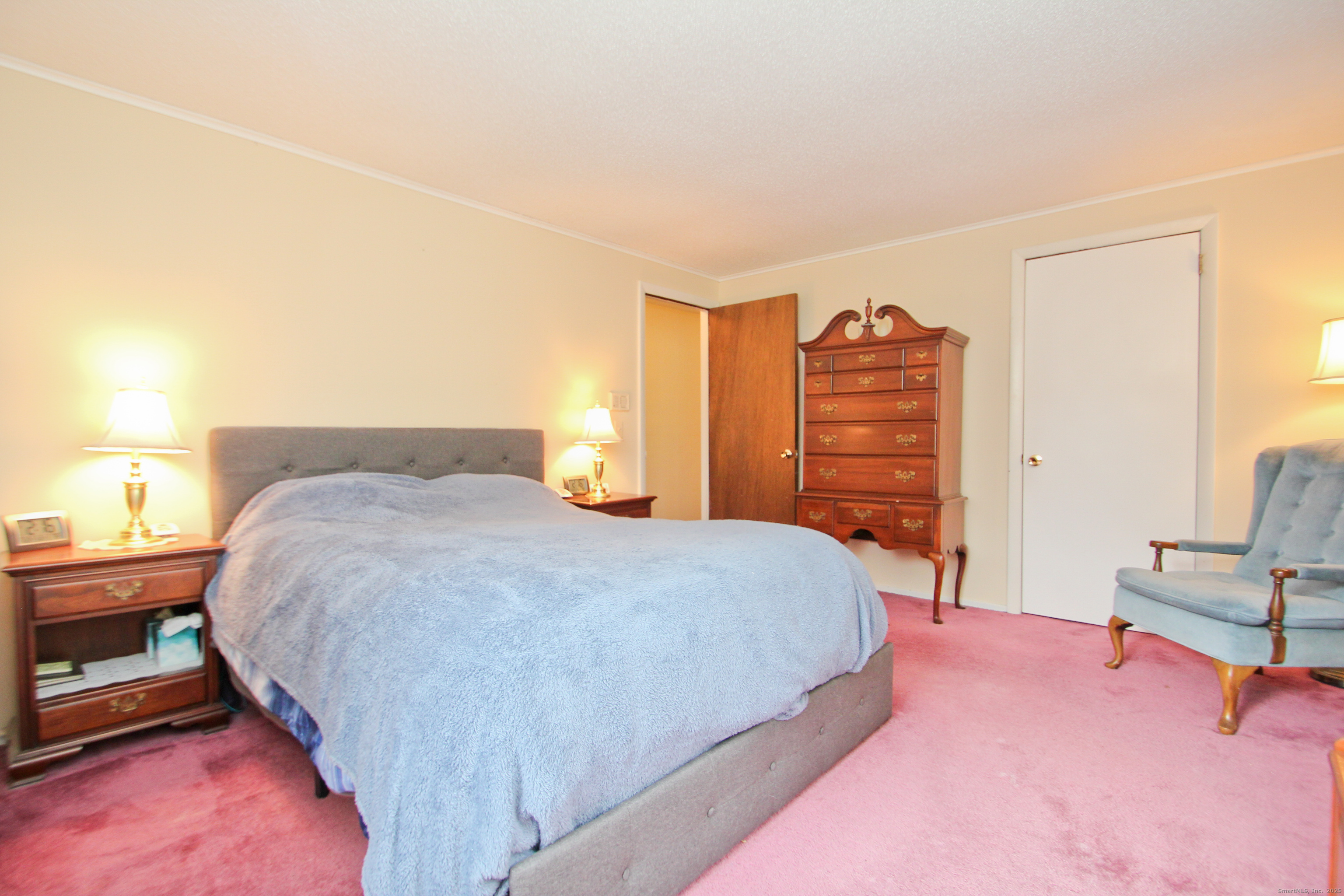 11 Northfield Road Enfield, CT 06082 - Photo 23 of 34 a bedroom with a bed and dresser with mirror