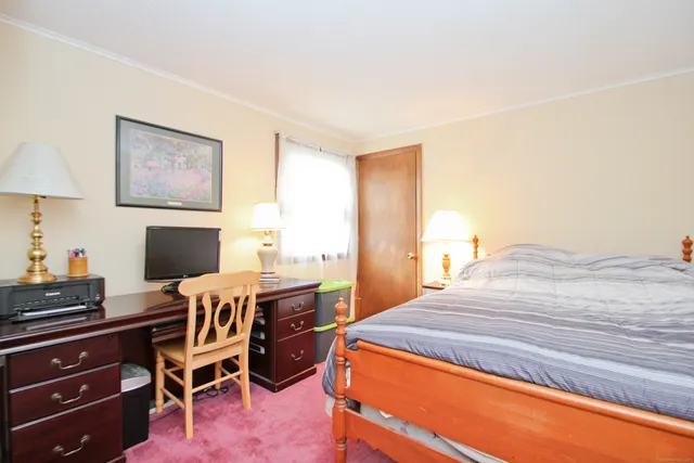 a bedroom with a bed and a workspace