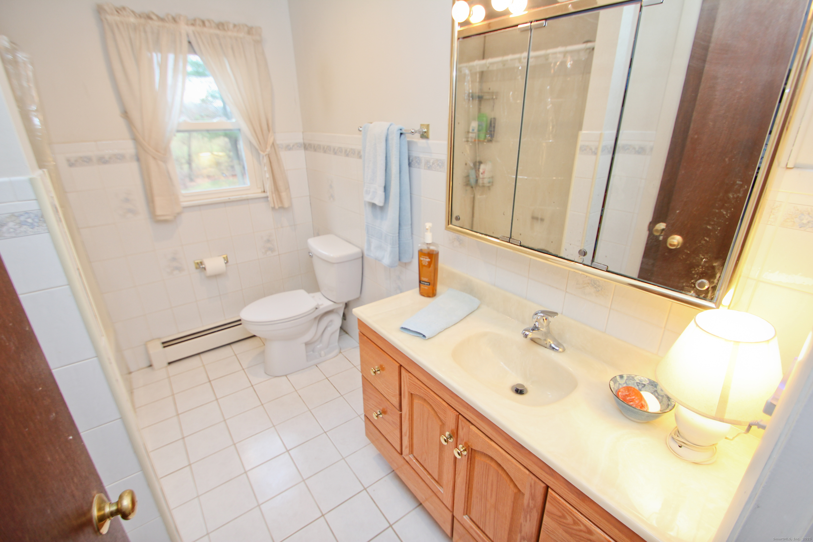 11 Northfield Road Enfield, CT 06082 - Photo 28 of 34 a bathroom with a double vanity sink toilet and mirror
