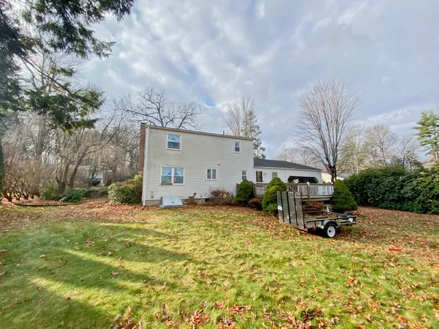 a backyard of a house with table and chairs