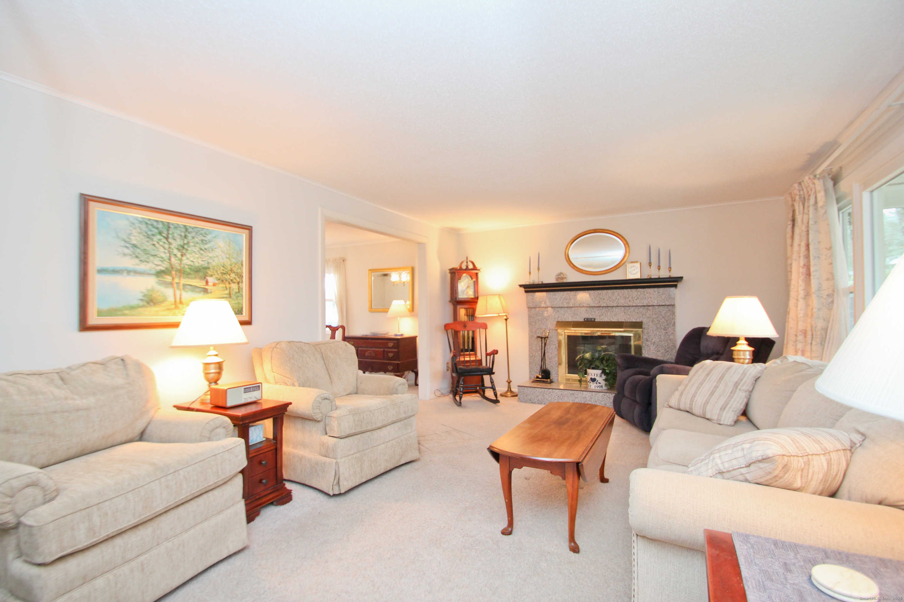11 Northfield Road Enfield, CT 06082 - Photo 4 of 34 a living room with furniture a fireplace and a large window
