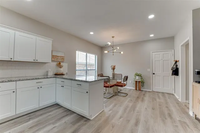 a large white kitchen with a large window