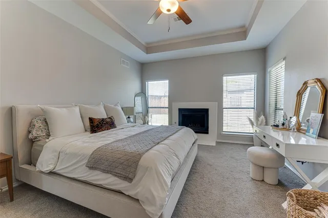 a spacious bedroom with a bed and a chandelier