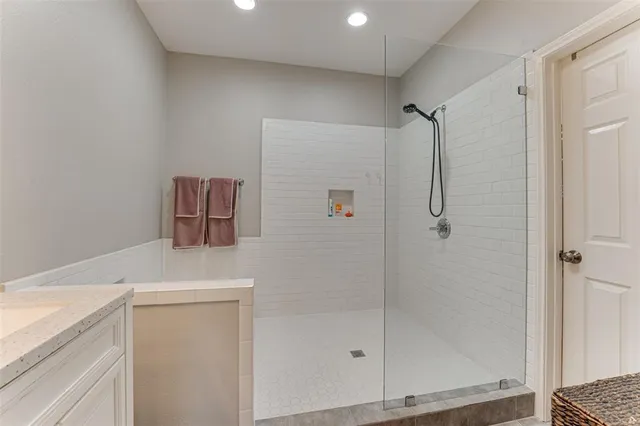 a bathroom with a shower and a sink