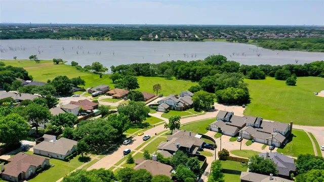 an aerial view of a house with outdoor space and lake view