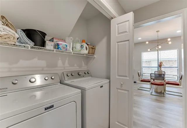 a view of washer and dryer with kitchen view