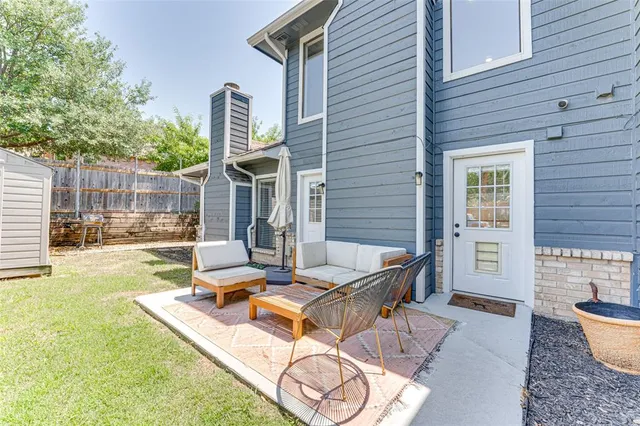 a view of a house with backyard and sitting area