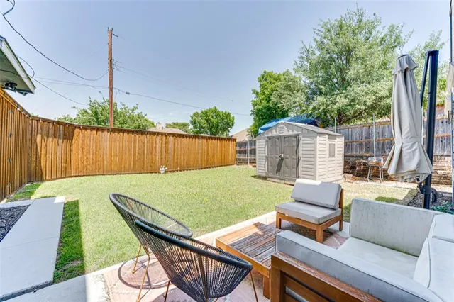 a backyard of a house with table and chairs