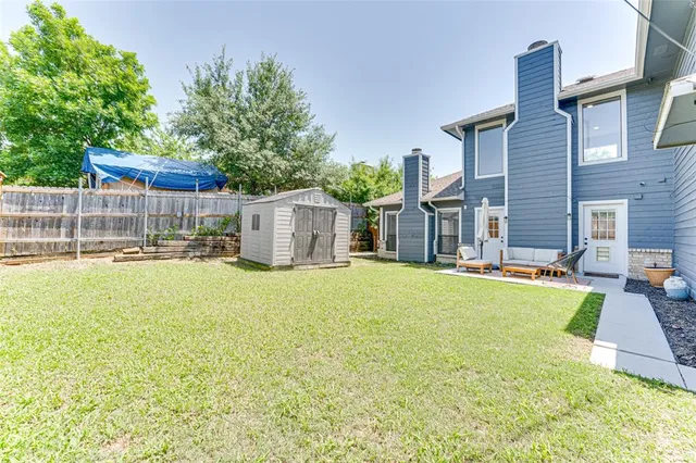a swimming pool with outdoor seating and yard
