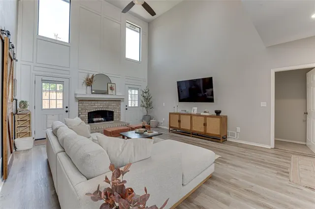 a living room with furniture a fireplace and a flat screen tv