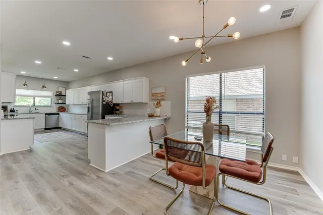 a view of kitchen with microwave and cabinets