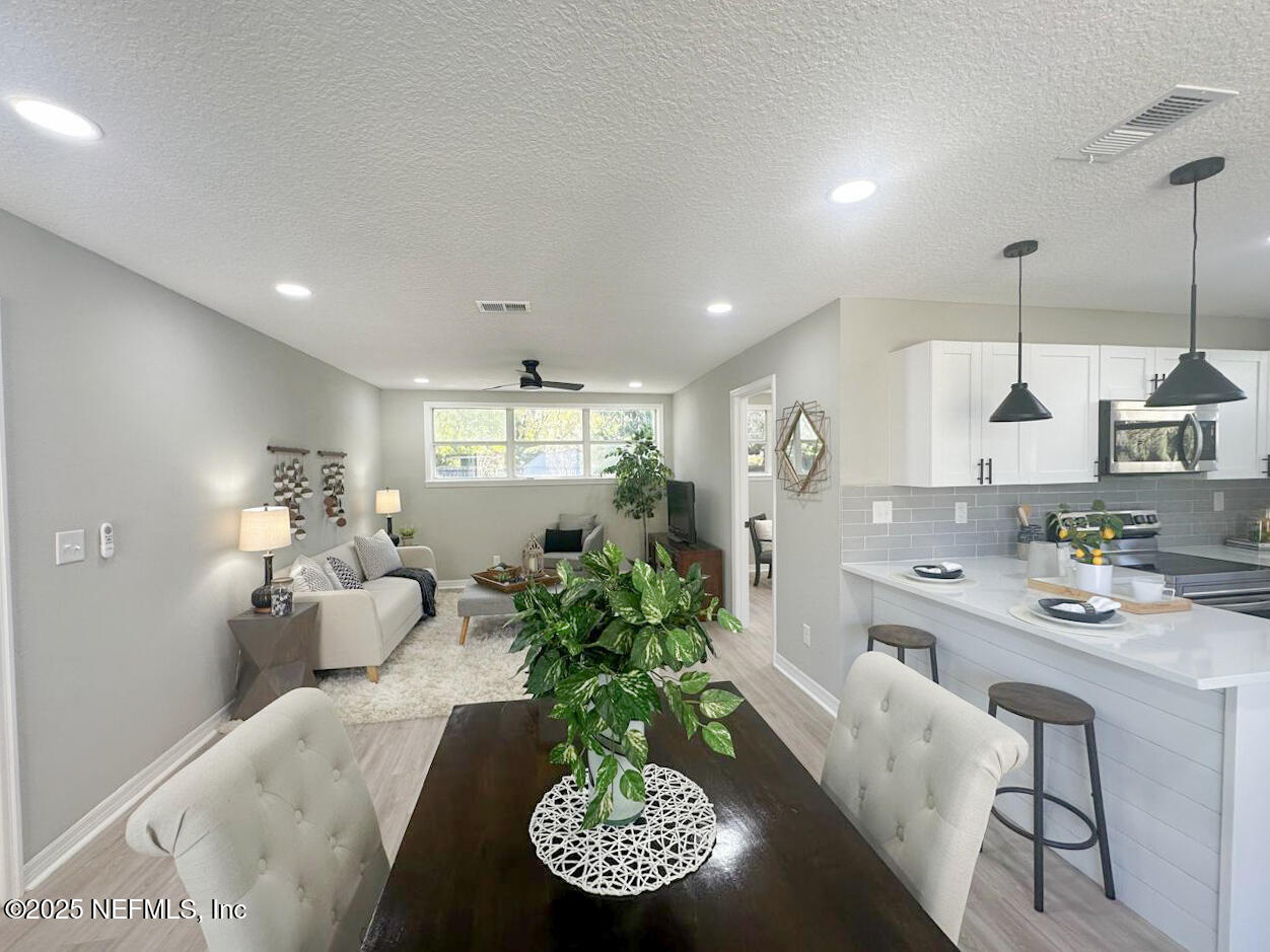 1336 Morgana Road Jacksonville, FL 32211 - Photo 13 of 36 a room with stainless steel appliances kitchen island granite countertop furniture and a view of kitchen