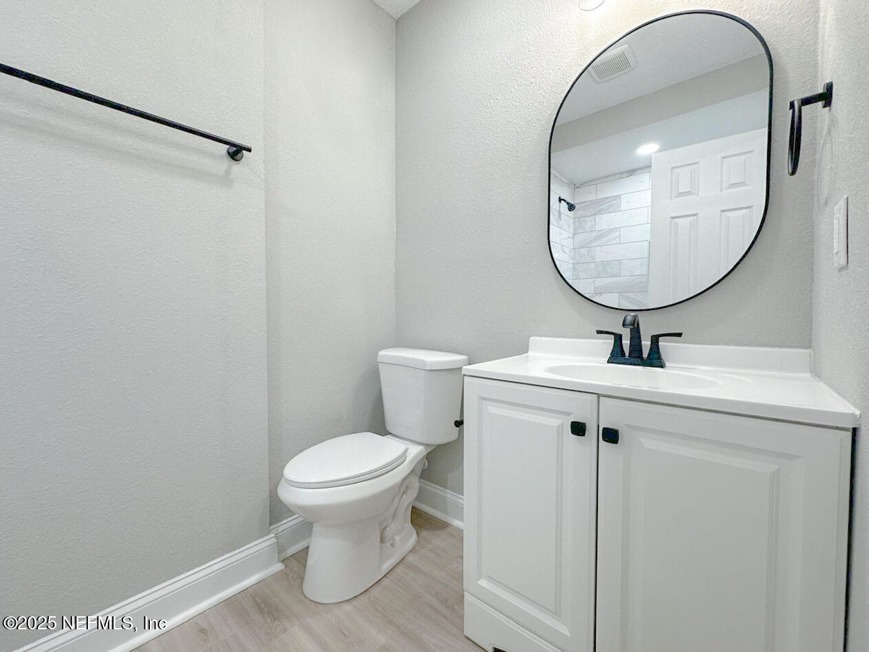 1336 Morgana Road Jacksonville, FL 32211 - Photo 22 of 36 a bathroom with a sink a mirror and a toilet