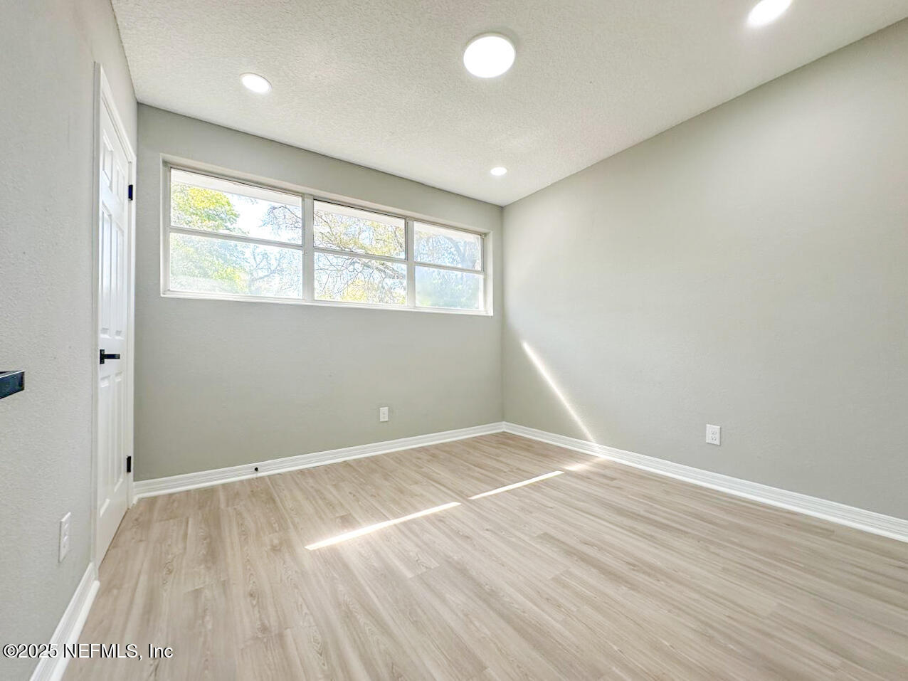 1336 Morgana Road Jacksonville, FL 32211 - Photo 24 of 36 an empty room with wooden floor and windows