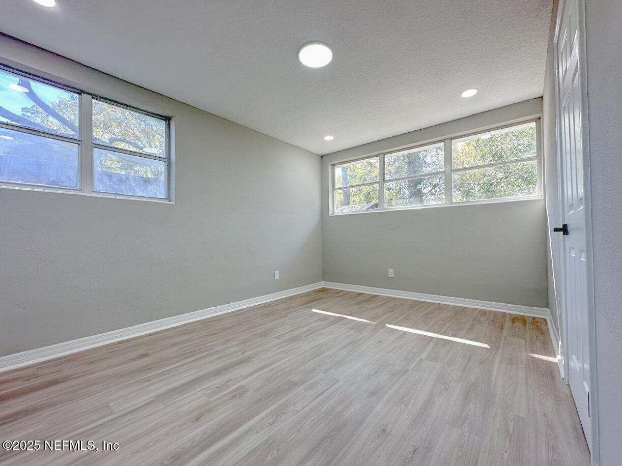1336 Morgana Road Jacksonville, FL 32211 - Photo 30 of 36 an empty room with wooden floor and windows