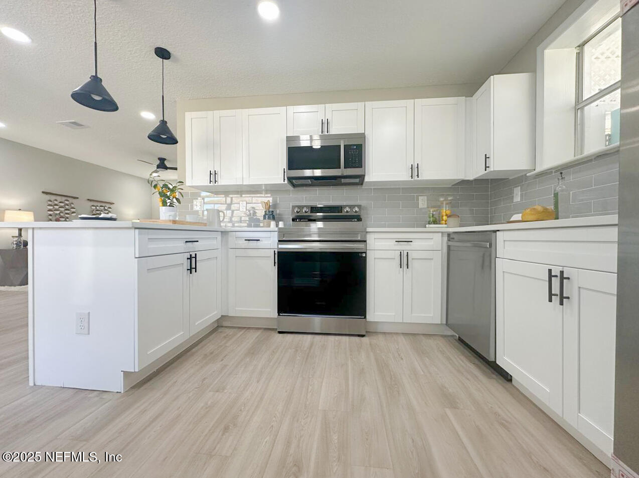 1336 Morgana Road Jacksonville, FL 32211 - Photo 4 of 36 a kitchen with stainless steel appliances granite countertop a stove sink and cabinets