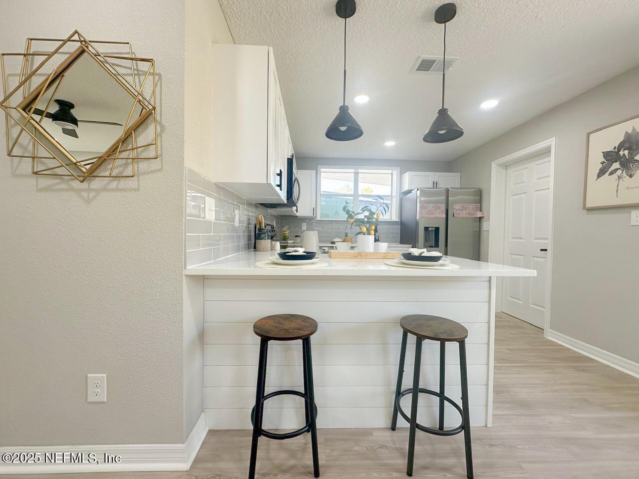 1336 Morgana Road Jacksonville, FL 32211 - Photo 8 of 36 a kitchen with stainless steel appliances a table chairs and white cabinets