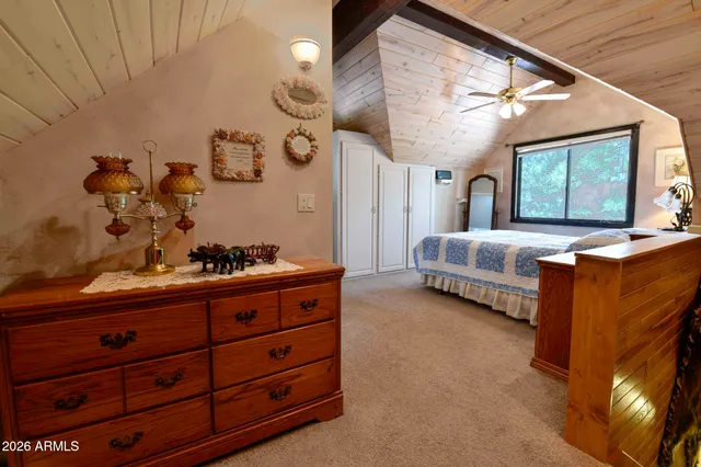 a spacious bedroom with a bed and a chandelier