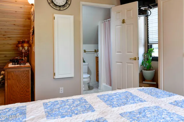 a bedroom with a bed and a mirror