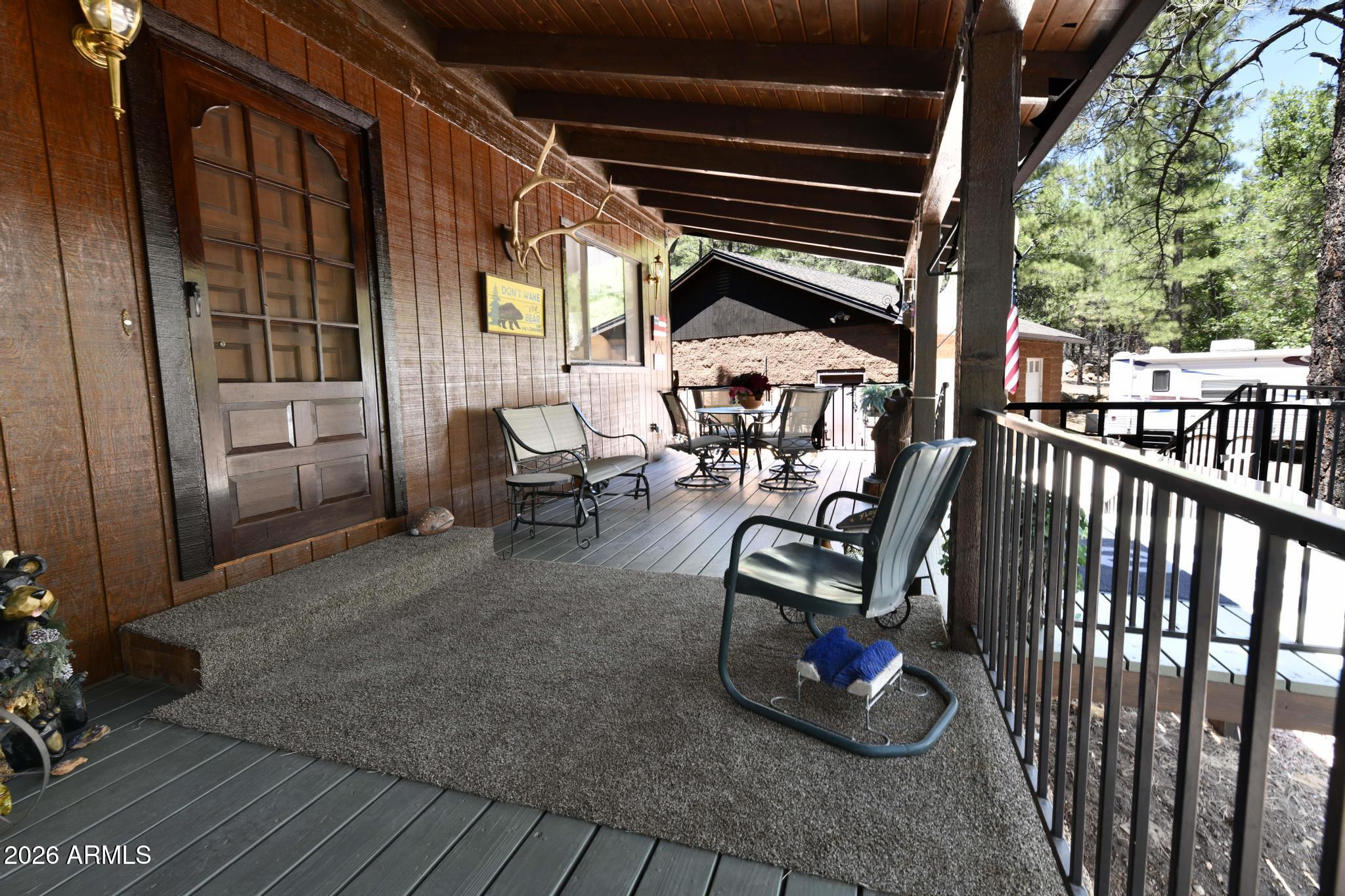 1018 Reata Pass Happy Jack, AZ 86024 - Photo 33 of 33 a view of a porch with furniture and floor to ceiling window