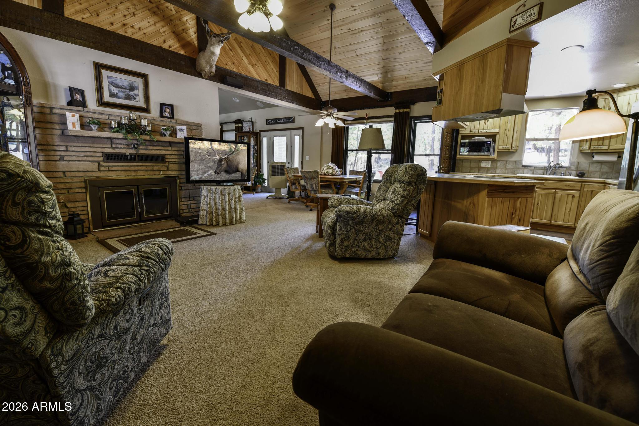 1018 Reata Pass Happy Jack, AZ 86024 - Photo 7 of 33 a view of a patio with couches table and chairs under an umbrella