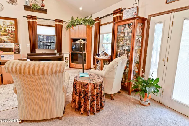 a dining room with furniture and a potted plant