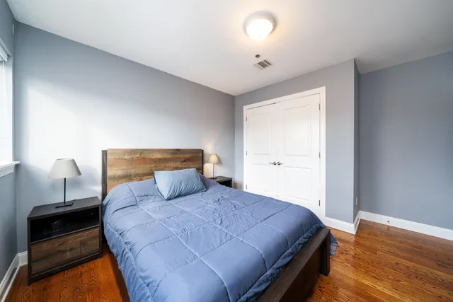 a bed room with a bed and a night stand