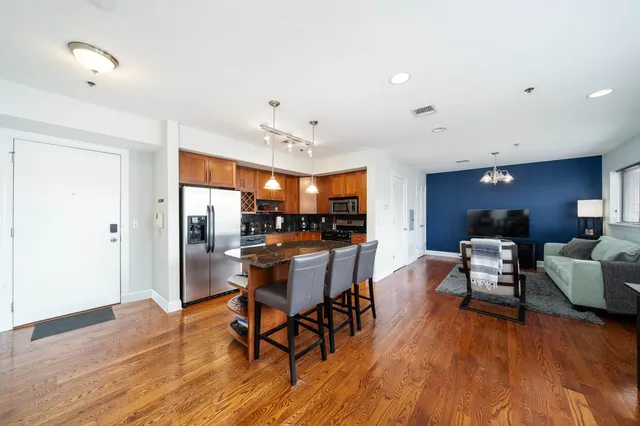 a view of a dining room with furniture and wooden floor