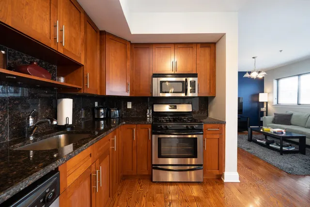 a kitchen with stainless steel appliances and wood cabinets