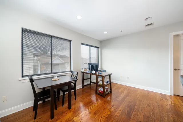 a view of a dining room with furniture and wooden floor