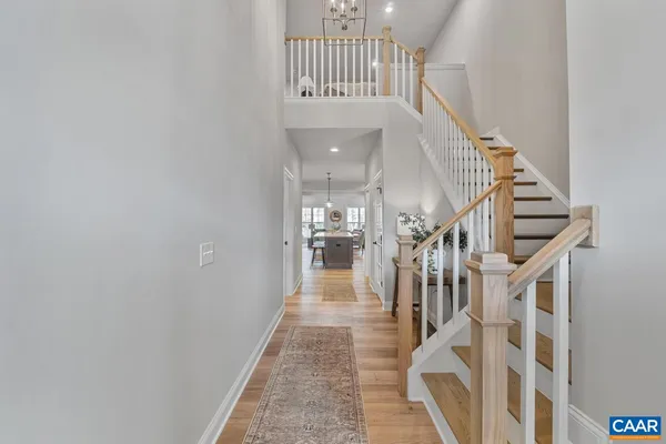 a view of entryway and hall with wooden floor